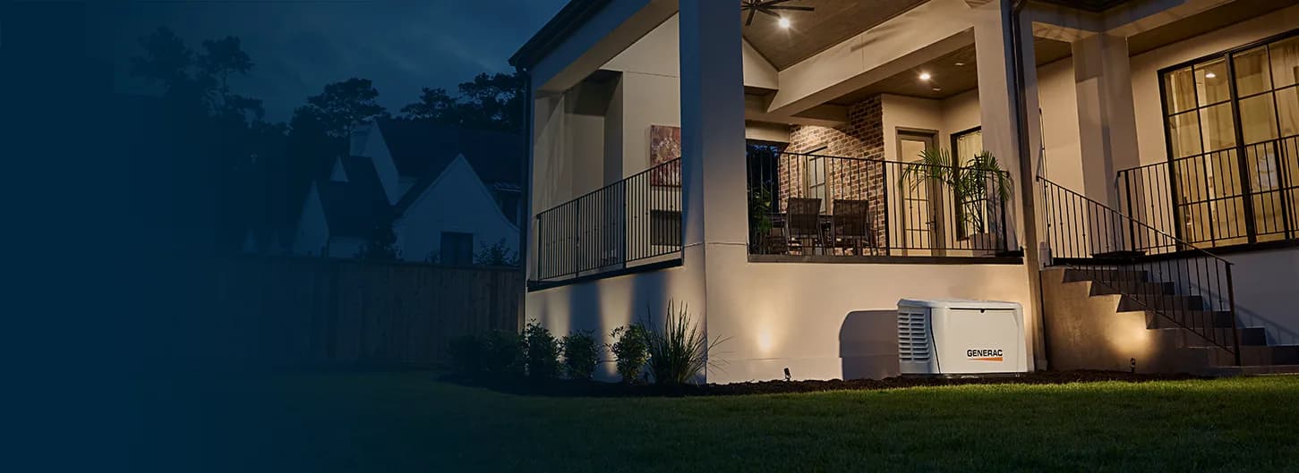 Generac Guardian standby generator keeping a home lit at night